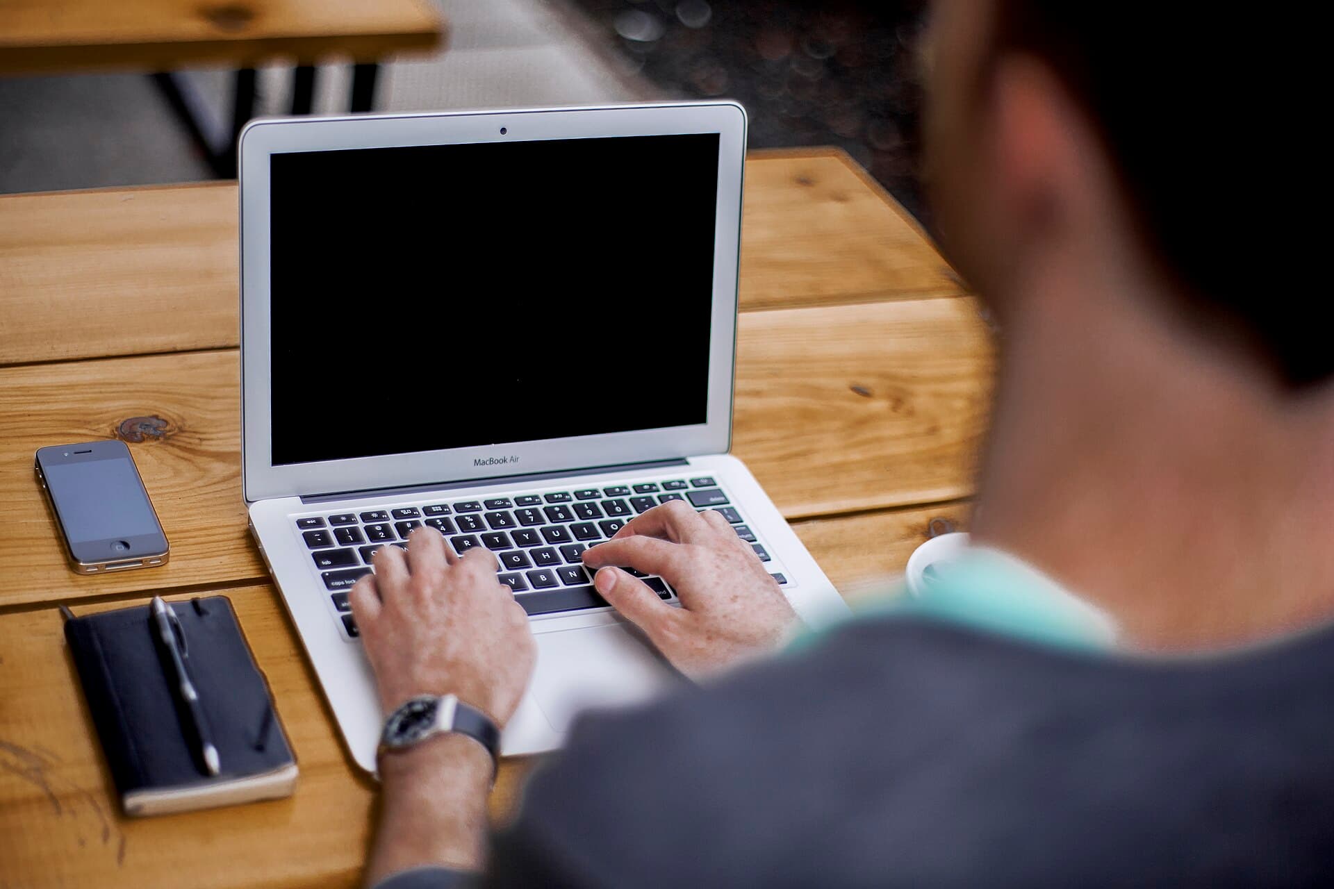 Hands typing on a laptop keyboard